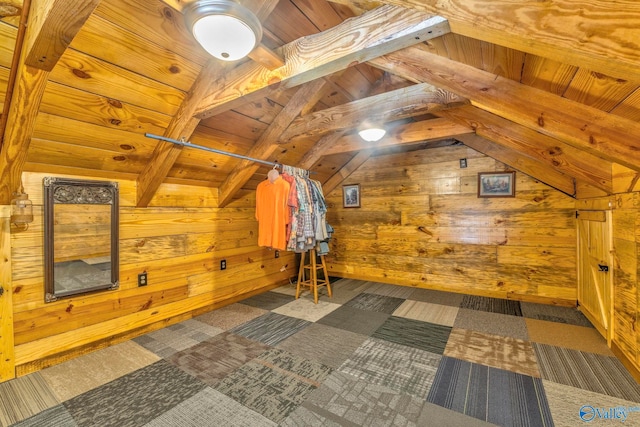 additional living space featuring wooden ceiling, beam ceiling, dark colored carpet, and wooden walls