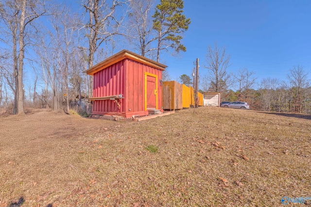 view of outbuilding with a lawn