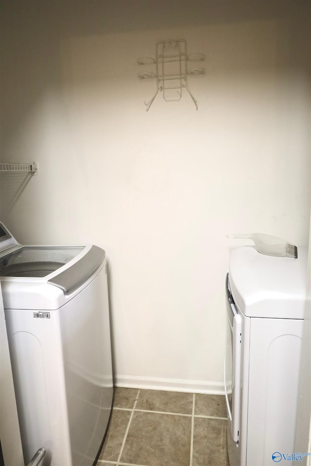 laundry area featuring washing machine and dryer and tile patterned floors