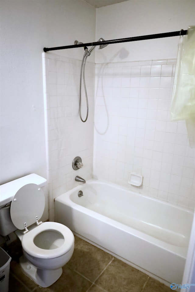 bathroom featuring toilet, tile patterned floors, and tiled shower / bath combo