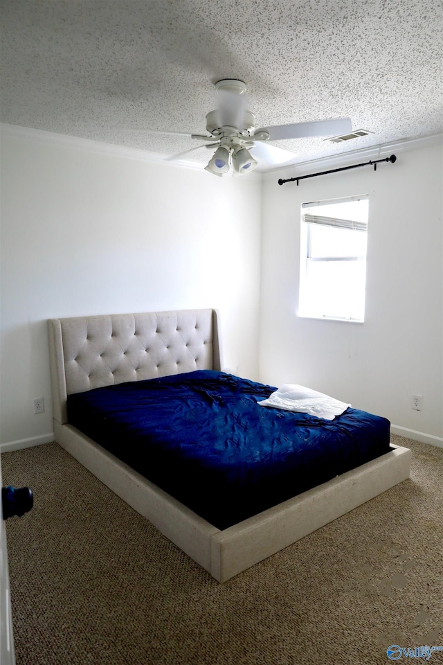 unfurnished bedroom with a textured ceiling, ceiling fan, and carpet flooring