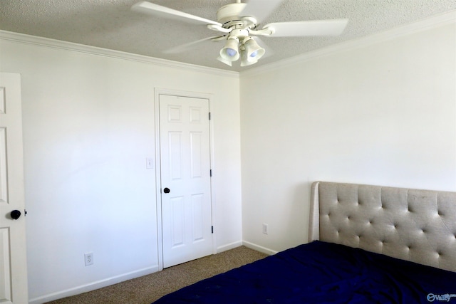 unfurnished bedroom with carpet floors, a textured ceiling, ceiling fan, and ornamental molding