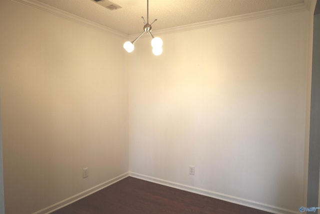 unfurnished room featuring a textured ceiling, a notable chandelier, wood-type flooring, and crown molding