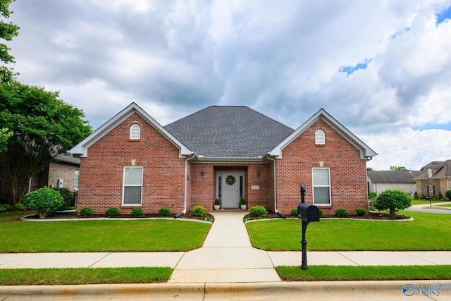 809 Milton Pl SW, Decatur, AL 35603 - traditional-style home featuring brick siding, a front lawn, and roof with shingles
