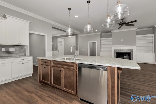 kitchen featuring a kitchen island with sink, dishwasher, sink, ceiling fan, and white cabinets