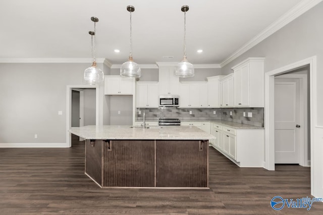 kitchen featuring a kitchen island with sink, light stone countertops, hanging light fixtures, appliances with stainless steel finishes, and white cabinets