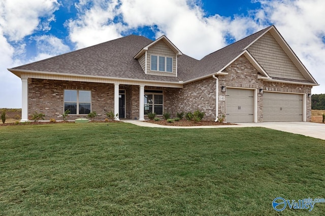 view of front facade featuring driveway, a front yard, brick siding, a shingled roof, and a garage