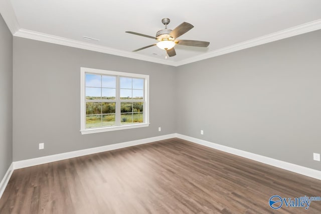spare room featuring a ceiling fan, ornamental molding, dark wood-type flooring, and baseboards
