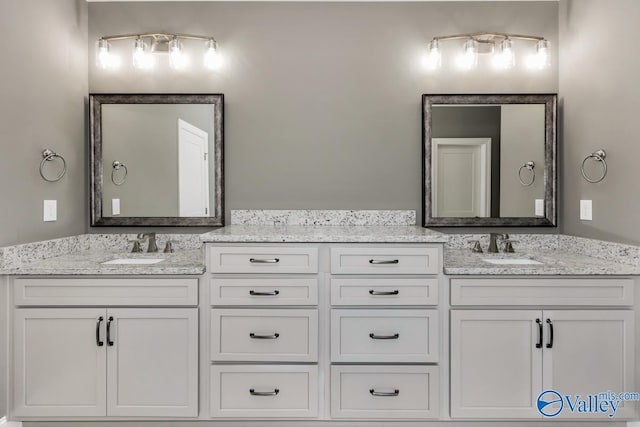 bathroom with double vanity and a sink
