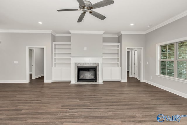 unfurnished living room featuring ceiling fan, ornamental molding, dark hardwood / wood-style flooring, and a fireplace