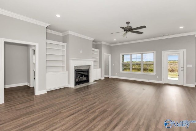 unfurnished living room with baseboards, dark wood-type flooring, crown molding, and ceiling fan
