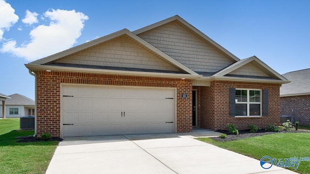 view of front of house with cooling unit, a garage, and a front yard