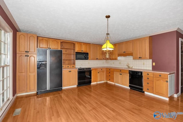 kitchen with visible vents, open shelves, black appliances, light countertops, and light wood-type flooring