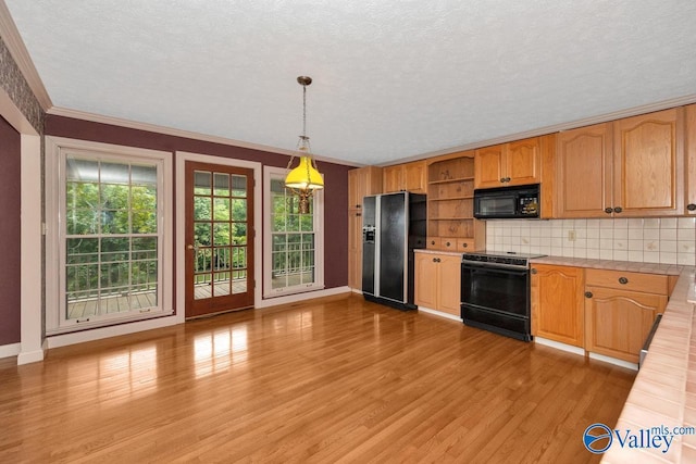 kitchen with light wood finished floors, black appliances, light countertops, and open shelves