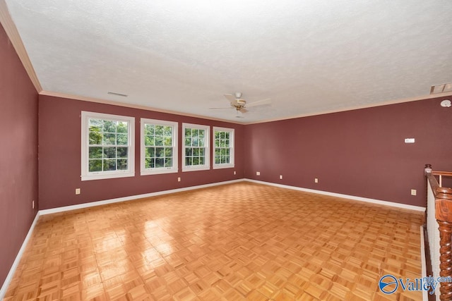 spare room with visible vents, ornamental molding, a ceiling fan, a textured ceiling, and baseboards
