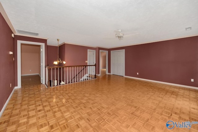 empty room with visible vents, baseboards, ornamental molding, ceiling fan with notable chandelier, and a textured ceiling