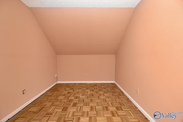 bonus room featuring baseboards and lofted ceiling