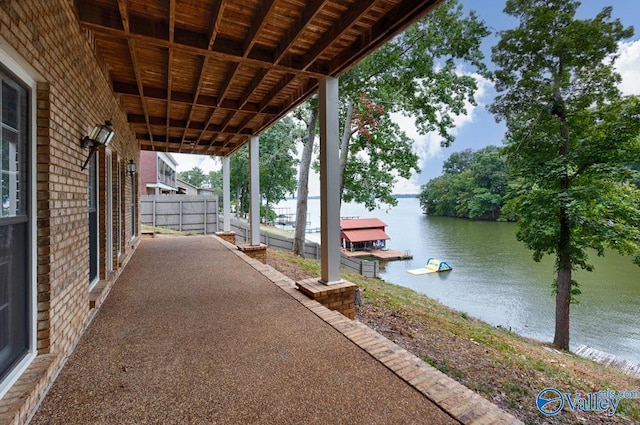 view of patio featuring a water view and a boat dock
