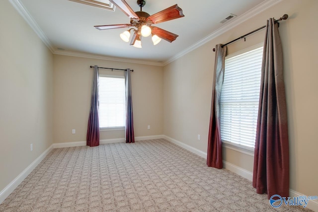 spare room with carpet, visible vents, a ceiling fan, and ornamental molding