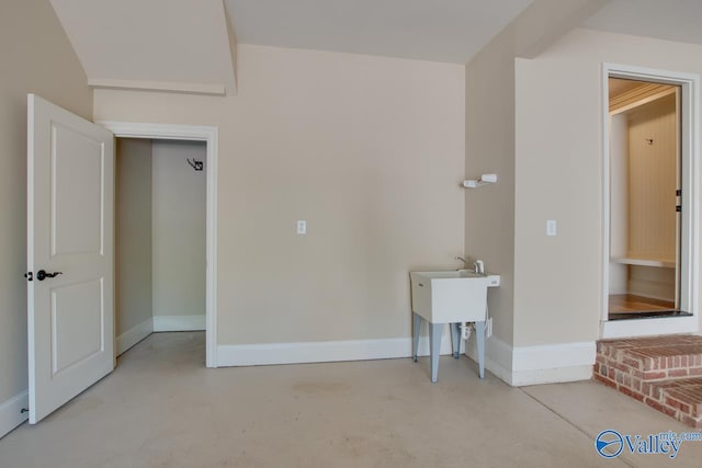 interior space with concrete floors and baseboards