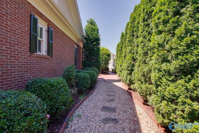 view of side of property featuring brick siding