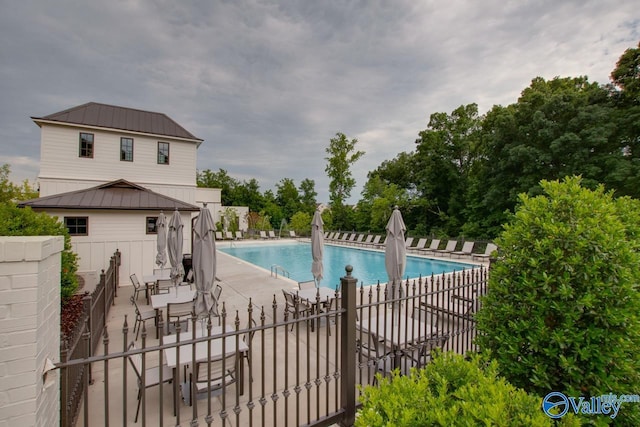 pool featuring a patio and fence