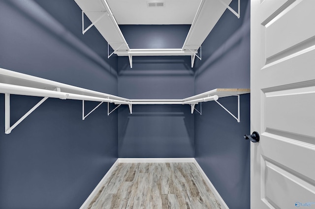 walk in closet featuring hardwood / wood-style flooring