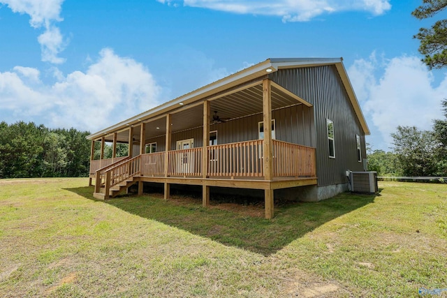 exterior space featuring central air condition unit and a lawn