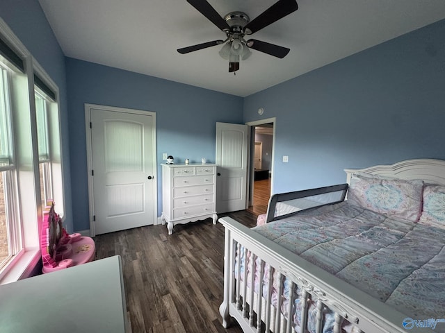 bedroom with ceiling fan and dark wood-type flooring