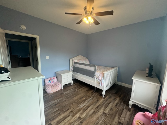 bedroom with dark hardwood / wood-style floors and ceiling fan