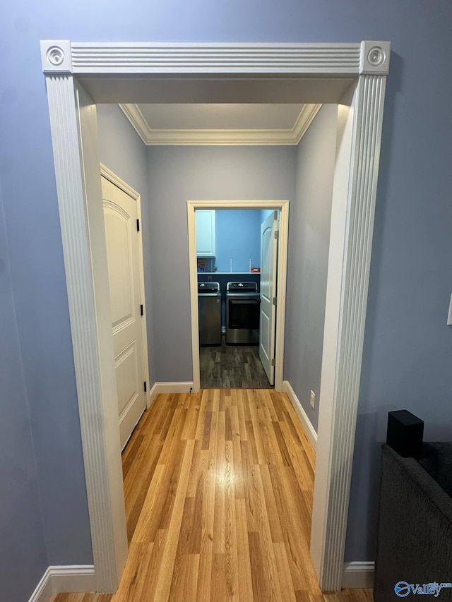 corridor with crown molding and light hardwood / wood-style flooring