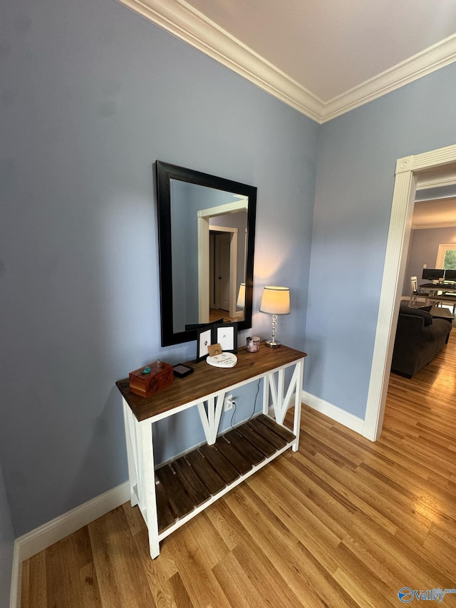 corridor featuring crown molding and hardwood / wood-style flooring