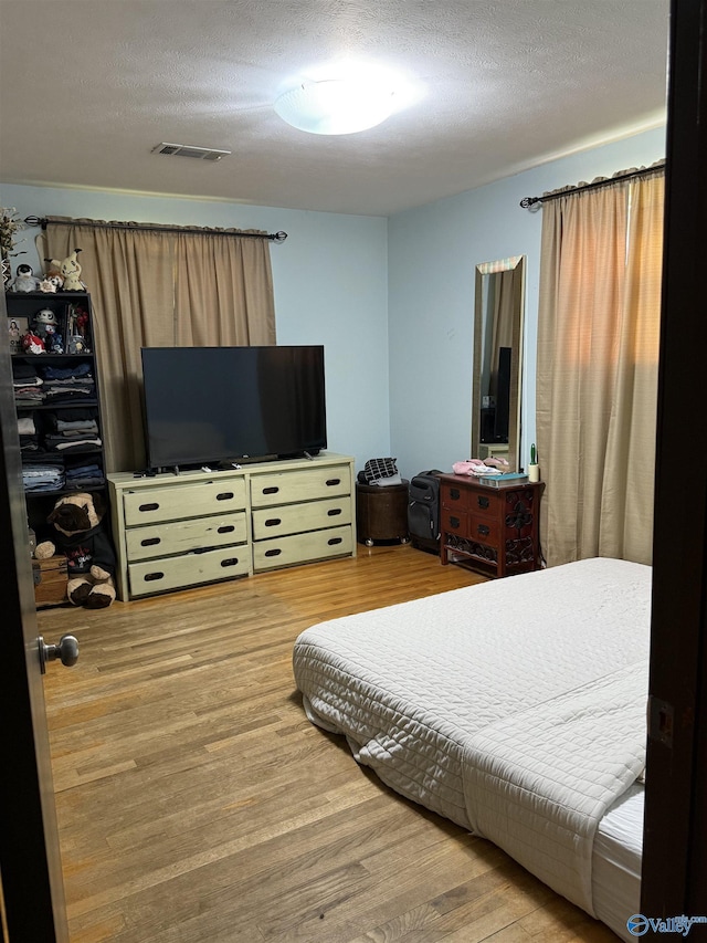 528 Delaney Rd, Huntsville, AL 35806 - bedroom featuring wood finished floors and a textured ceiling