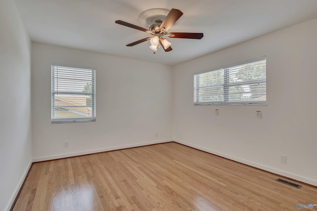 1126 Oster Dr, Huntsville, AL 35816 - unfurnished room featuring light wood finished floors, plenty of natural light, visible vents, and baseboards