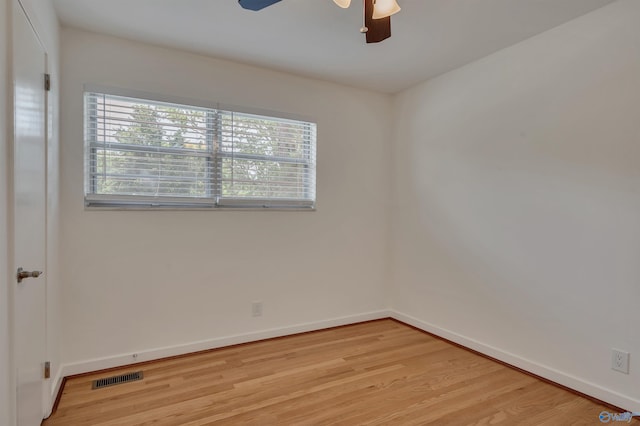 empty room with ceiling fan and light hardwood / wood-style flooring