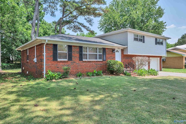 tri-level home featuring a garage, a front lawn, concrete driveway, and brick siding