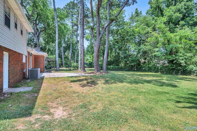 view of yard featuring a patio and central AC