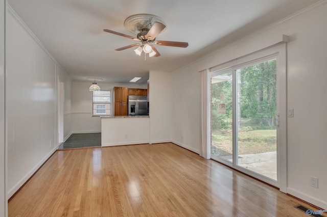 1126 Oster Dr, Huntsville, AL 35816 - unfurnished living room with ornamental molding, visible vents, and light wood-style flooring