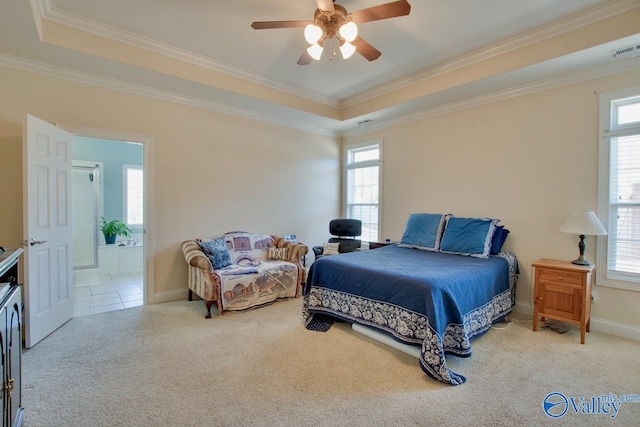 carpeted bedroom featuring multiple windows, a tray ceiling, and ornamental molding