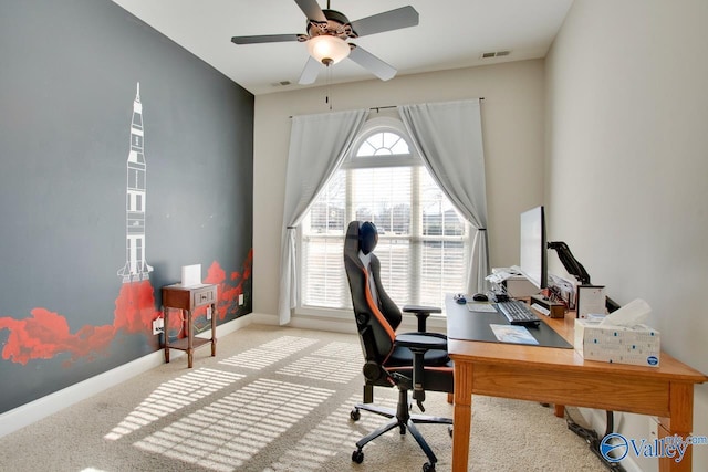 carpeted office with visible vents, ceiling fan, and baseboards