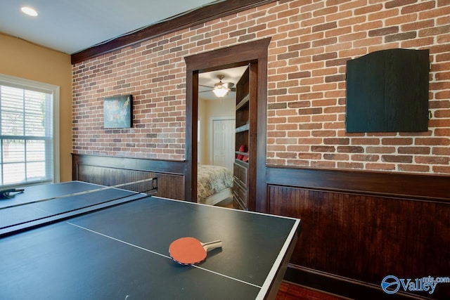 playroom featuring brick wall