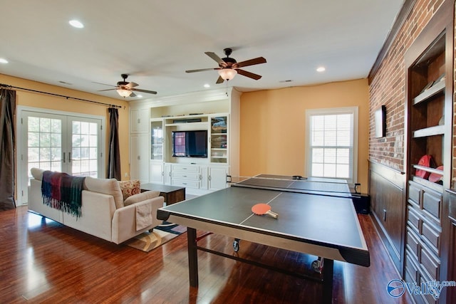 game room with a wealth of natural light, french doors, and dark wood-type flooring