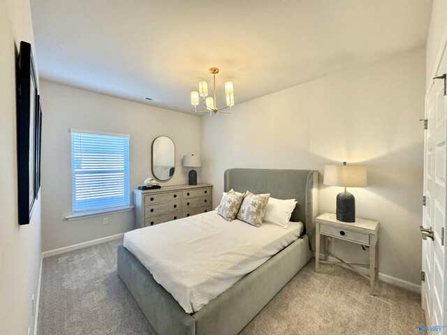 bedroom featuring light carpet and an inviting chandelier