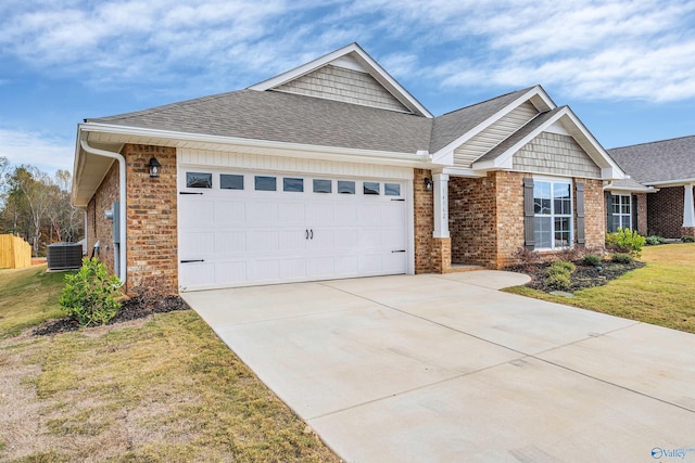 view of front of home with brick siding, an attached garage, central AC, driveway, and a front lawn