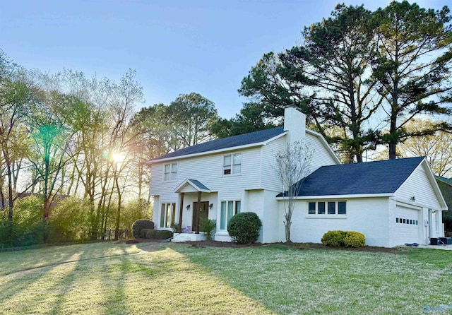 view of front of property with a chimney, a front yard, roof with shingles, and an attached garage