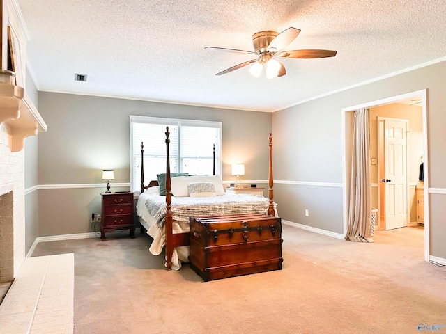 bedroom with a textured ceiling, ornamental molding, visible vents, and light colored carpet