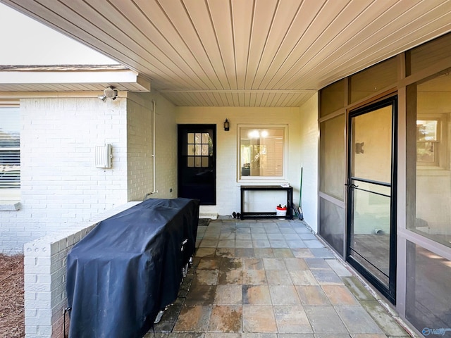 property entrance with brick siding
