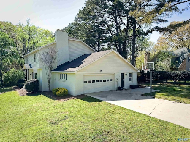 view of side of property featuring a chimney, driveway, a garage, and a lawn