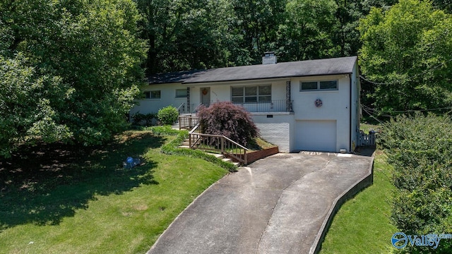 ranch-style home with a garage and a front yard