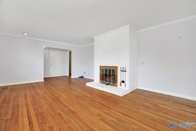 unfurnished living room with crown molding and light wood-type flooring